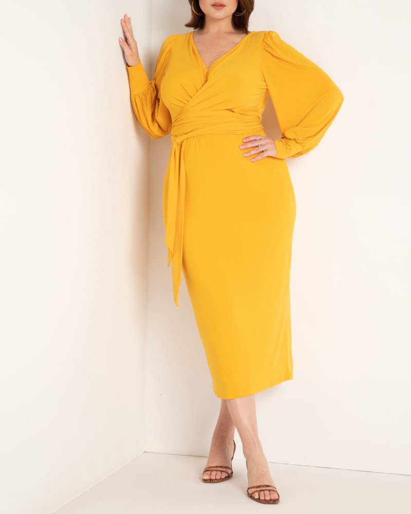 Front of a model wearing a size 28 Cross Front Midi Dress in Golden Glow by ELOQUII. | dia_product_style_image_id:284465